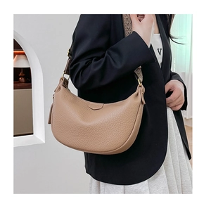 Detail of lychee pattern leather crescent bag with wide jacquard shoulder strap in khaki