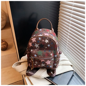 Detailed macro view of colorful star embroidery on a brown canvas mini backpack