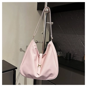 Detail view of pink large capacity Hobo tote bag with matte texture and metal buckle