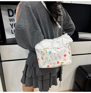 Detailed shot of white floral bag with heart prints and elegant lace drawstring edge
