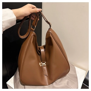 Detail of a brown hobo bag featuring a gold metal buckle and premium matte PU leather