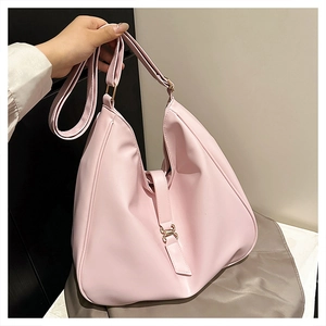 Detail view of pink leather hobo bag with adjustable strap and metal buckle hardware