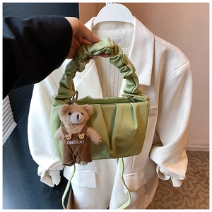 Detail of mint green pleated hobo bag with cute bear charm and scrunchie style handle