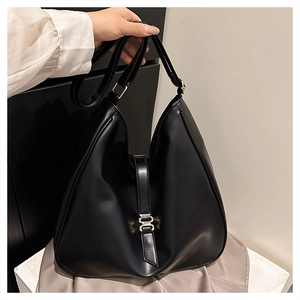Close-up of hobo bag showing the black matte texture and golden buckle detail