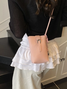Pink lychee grain leather bucket bag with silver horseshoe buckle shown on model