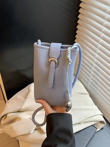 Light blue textured mini bucket bag with horseshoe buckle and silver heart charm