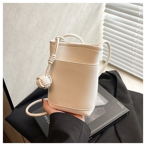 Detail of white litchi pattern mobile phone bag with unique woven spherical knot strap