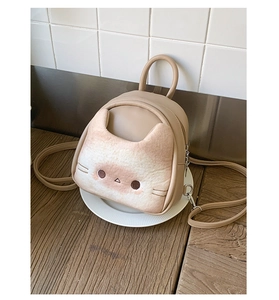 Close-up of a mini khaki cat-shaped backpack with a plush kitten head and PU leather straps