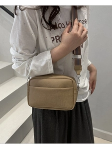 Lychee texture PU crossbody bag with wide striped strap in khaki shown on model