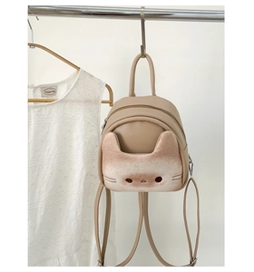 Detail of cute cat face pocket on milk tea mini backpack with silver hardware