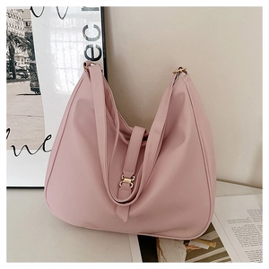 Detail view of pink large capacity tote bag with soft leather texture and metal buckle