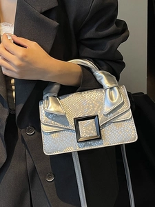 Silver snakeskin textured handbag with black buckle and twisted handle for women