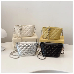 Detail of quilted chain bags in white, yellow, silver and black leather finishes