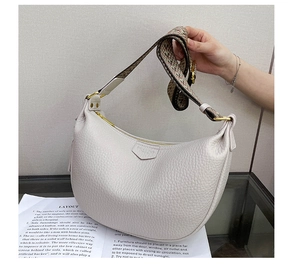 Detail of white lychee leather hobo bag with a colorful jacquard woven shoulder strap