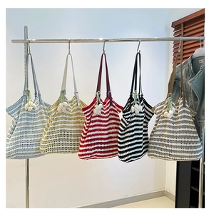 Detail of five striped crochet tote bags in various colors with leather handles