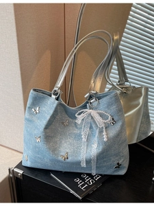 Blue denim shoulder bag with silver butterfly charms and elegant lace pearl bow