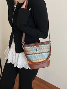 Rainbow woven bucket bag with brown leather base and metallic buckle for summer beach trips