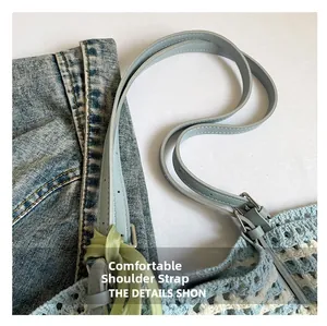 Detail of adjustable blue leather strap and honeycomb knit texture on striped tote bag