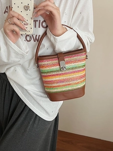 Rainbow woven straw bucket bag with colorful stripes and brown faux leather trim