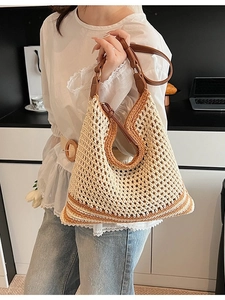 Chic hollow straw tote bag with brown leather handles and adjustable shoulder strap