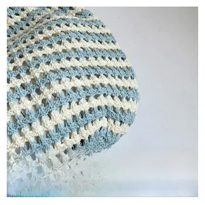 Detailed close-up of woven tote bag showing blue and beige knit texture and stitches