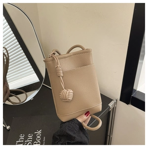 Detail view of khaki pebbled leather mini crossbody phone bag with woven knot strap