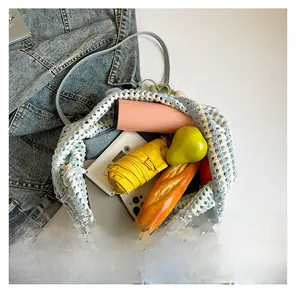 Macro view of blue knit tote bag showing spacious interior with daily essentials