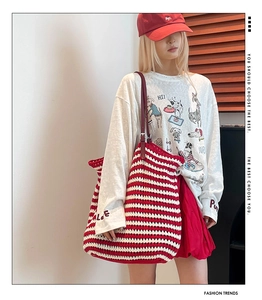 Red and white striped knit tote bag shown on model with casual daily outfit ensemble
