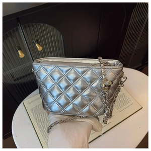 Close-up of silver quilted chain bucket bag with metallic cracked leather texture detail