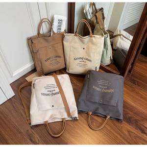 Close-up of stylish canvas tote bags with adjustable straps in four neutral colors