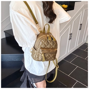 Close-up of olive green quilted mini backpack featuring elegant diamond stitching