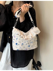 Floral print crossbody bag with delicate white lace trim and adjustable strap for women