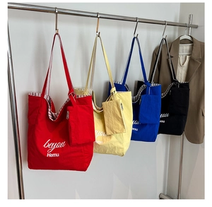 Detailed shot of various colored canvas tote bags with matching small pouches and liners