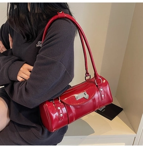 Detail of red bowling bag showing heart metal lock and silver decorative plate