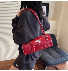 Close-up of red glossy patent leather bowling bag featuring a silver heart lock detail