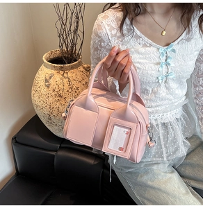 Detailed macro of pink glossy Boston bag featuring decorative transparent card slot design