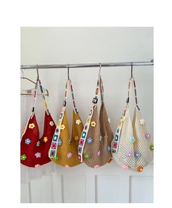 Detail view of colorful crochet tote bags with 3D handmade floral knit patterns