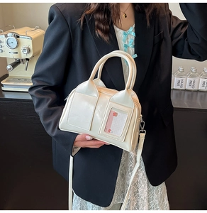 Detail of off-white vintage Boston bag featuring a clear card slot and wide top handle