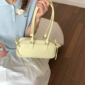 Close-up of yellow faux leather shoulder bag with JINGPIN logo and drawstring detail