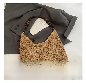 Detail shot of handwoven straw beach bag with retro dark brown wooden bead handles