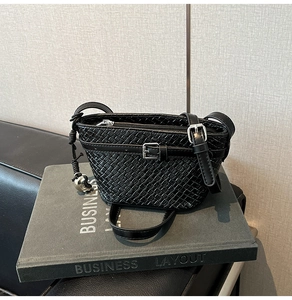 Dettaglio borsa a tracolla intrecciata con fibbia argentata e tracolla in pelle