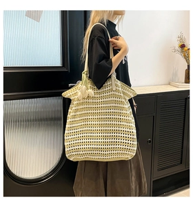 Detail view of large striped crochet tote with white tulip charms and woven texture