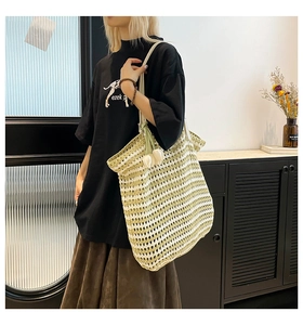Detail showing green and white striped woven tote bag with a tulip charm accessory