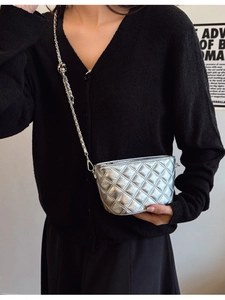 Chic silver quilted crossbody bucket bag with metallic chain and sphere adjustment buckle