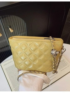 Chic bright yellow quilted leather chain shoulder bag with metal ball charm on book