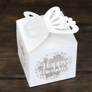 Detail of laser-cut butterfly design on a white Happy Birthday party favor candy box