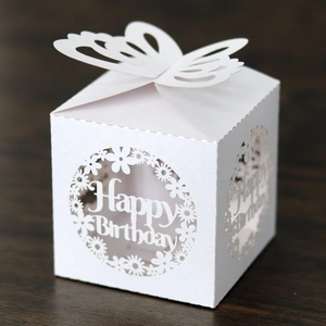 Detail of white laser-cut birthday favor box with butterfly top and Happy Birthday text