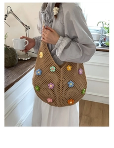Detail of light brown hollow knit tote bag featuring colorful 3D crochet flowers