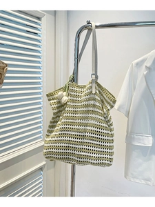 Knitted stripe tote bag with yellow and white pattern and tulip flower pendant charm