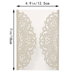 Macro detail of laser-cut glitter gold wedding invitation cover with lace pattern